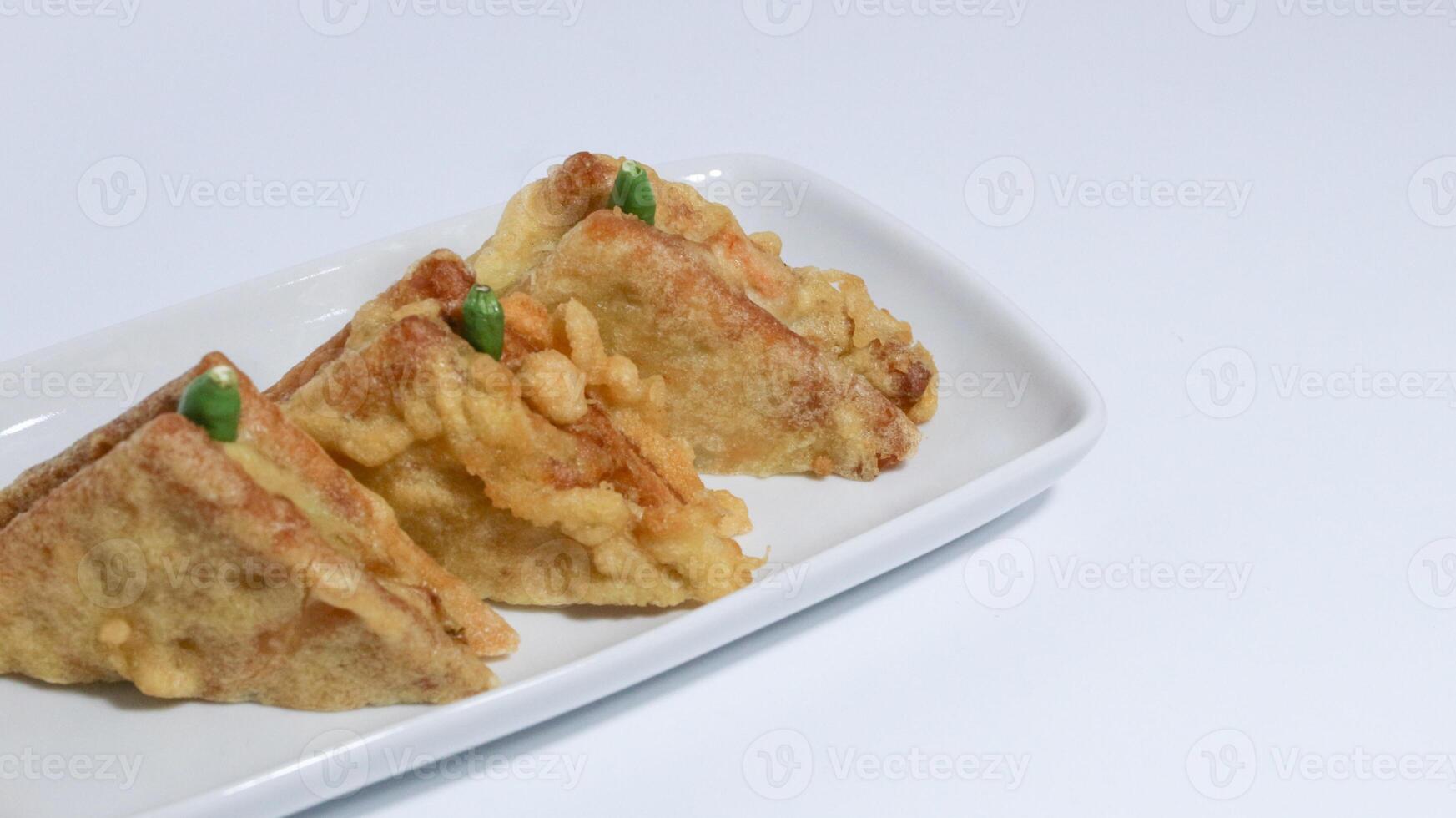 Roti Goreng is common fritter snack in Indonesia which made of white bread filled with creamy chicken and vegetable. photo