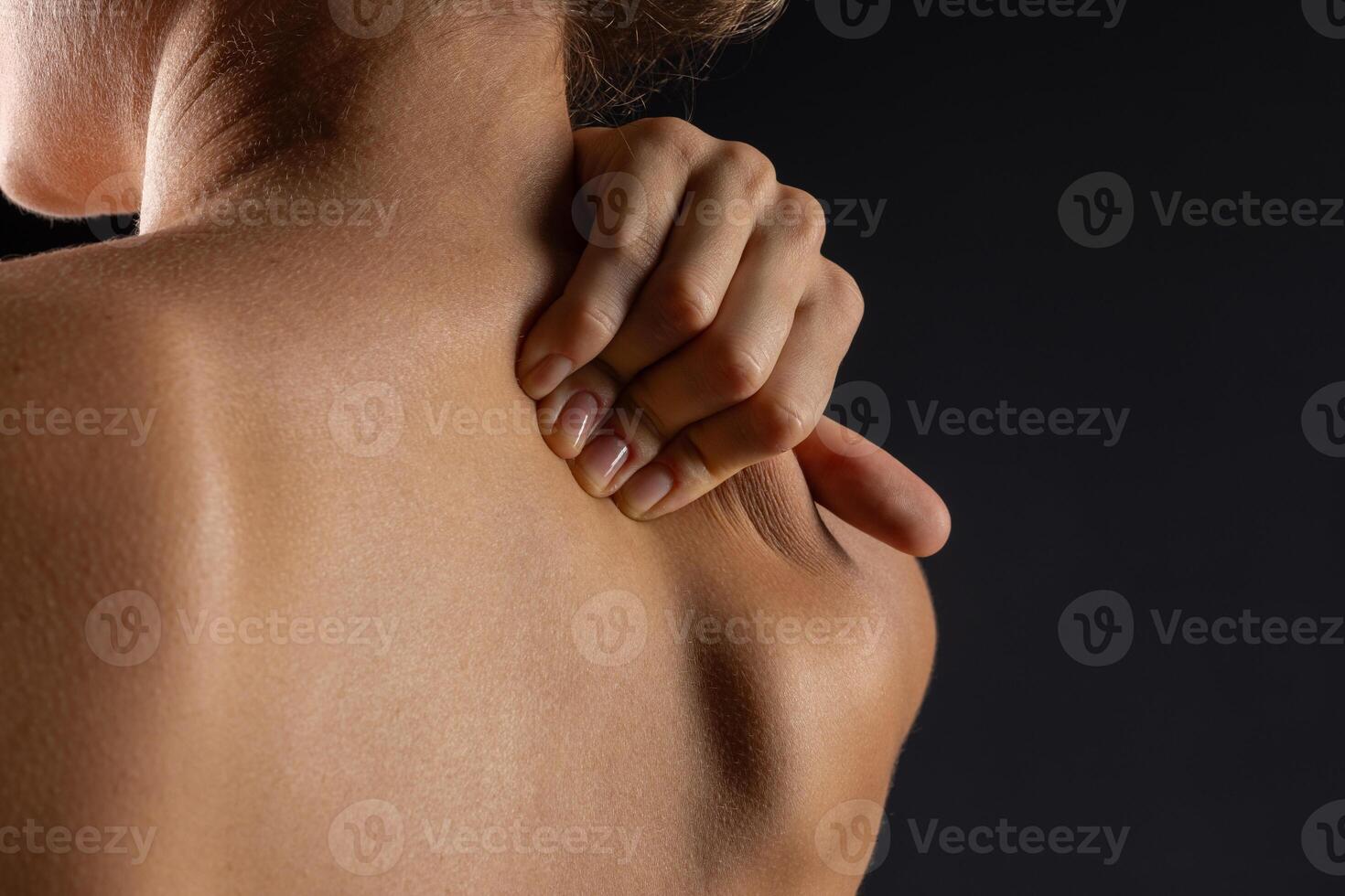 woman massaging neck close up, concept of neck pain with osteochondrosis protrusion and hernia photo