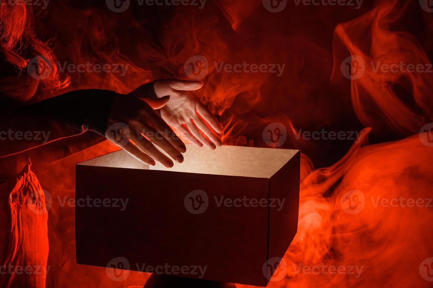 Man opens magic box with surprise on dark background, mystical box, surprise, halloween photo