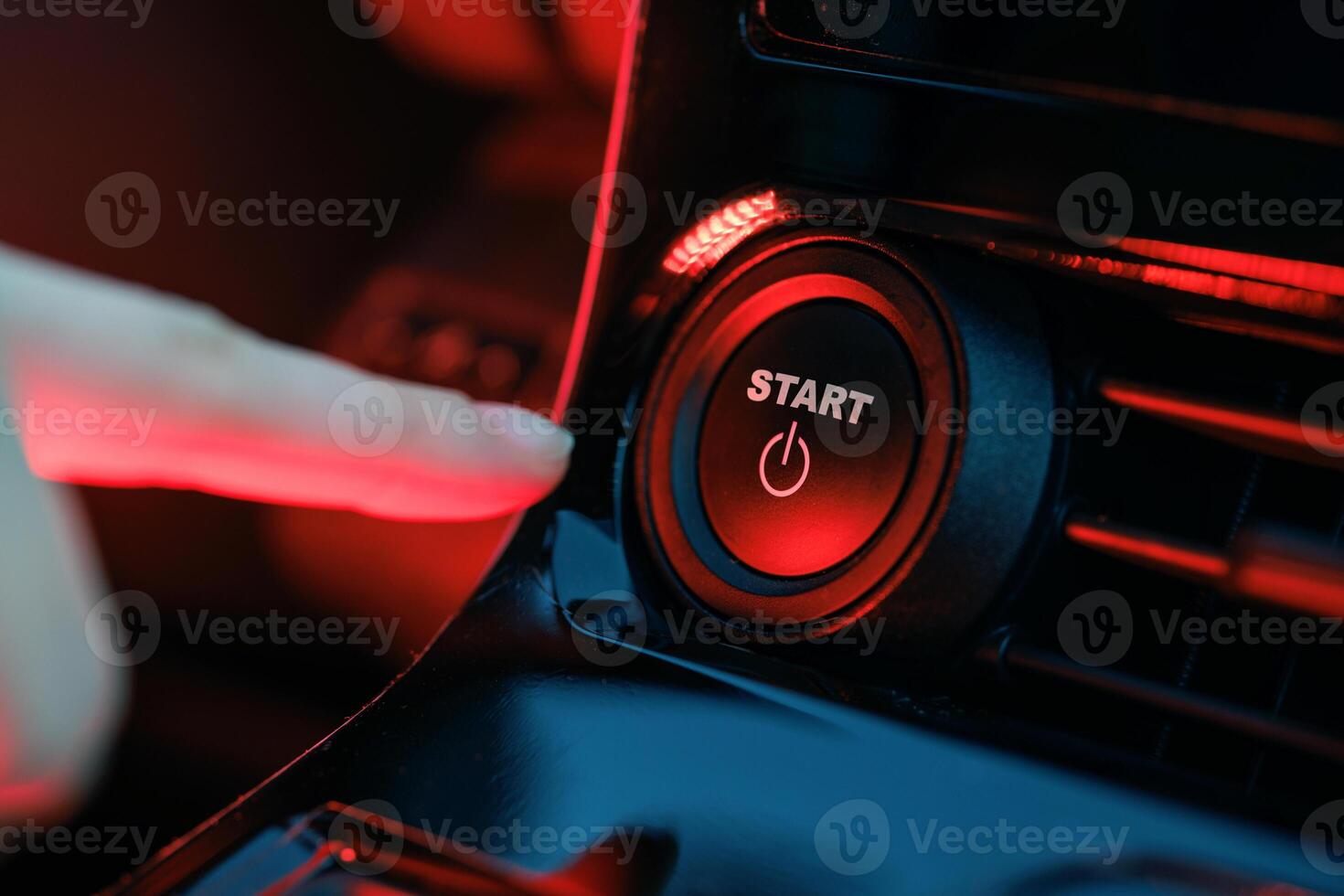 hand pressing start button on car panel, action activation concept photo