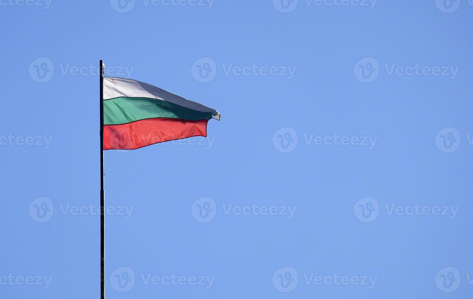 The national flag of Bulgaria in the wind against a blue sky photo