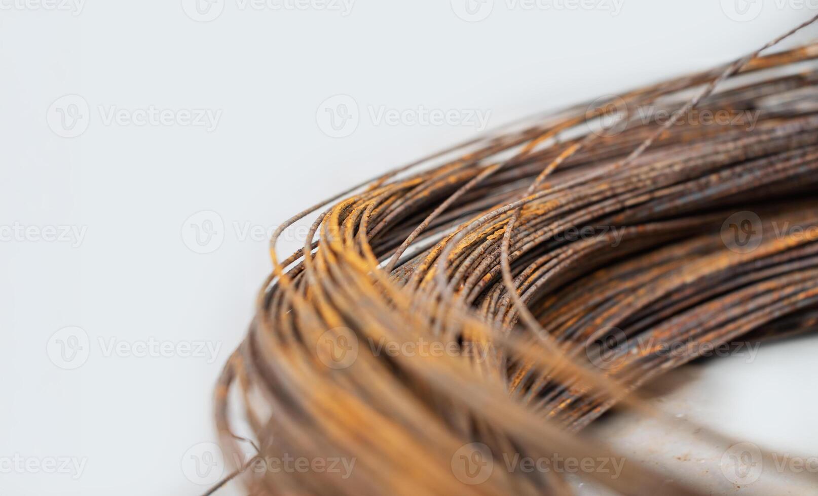 Rusty coil of wires captured up close on a light background photo