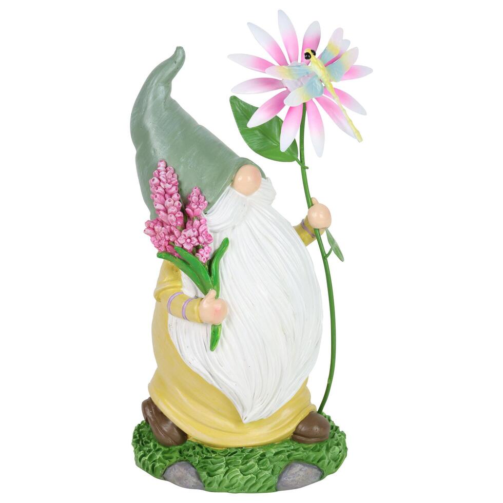 A gnome statue with a flower and a butterfly photo