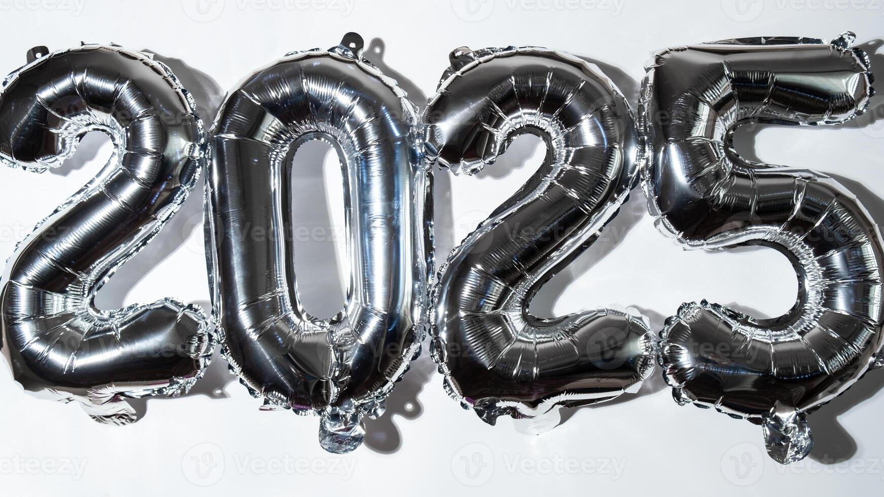 Happy new year 2025 metallic balloons on white background. Greeting card silver foil balloons numbers Christmas holiday concept. Celebration party congratulation decoration photo