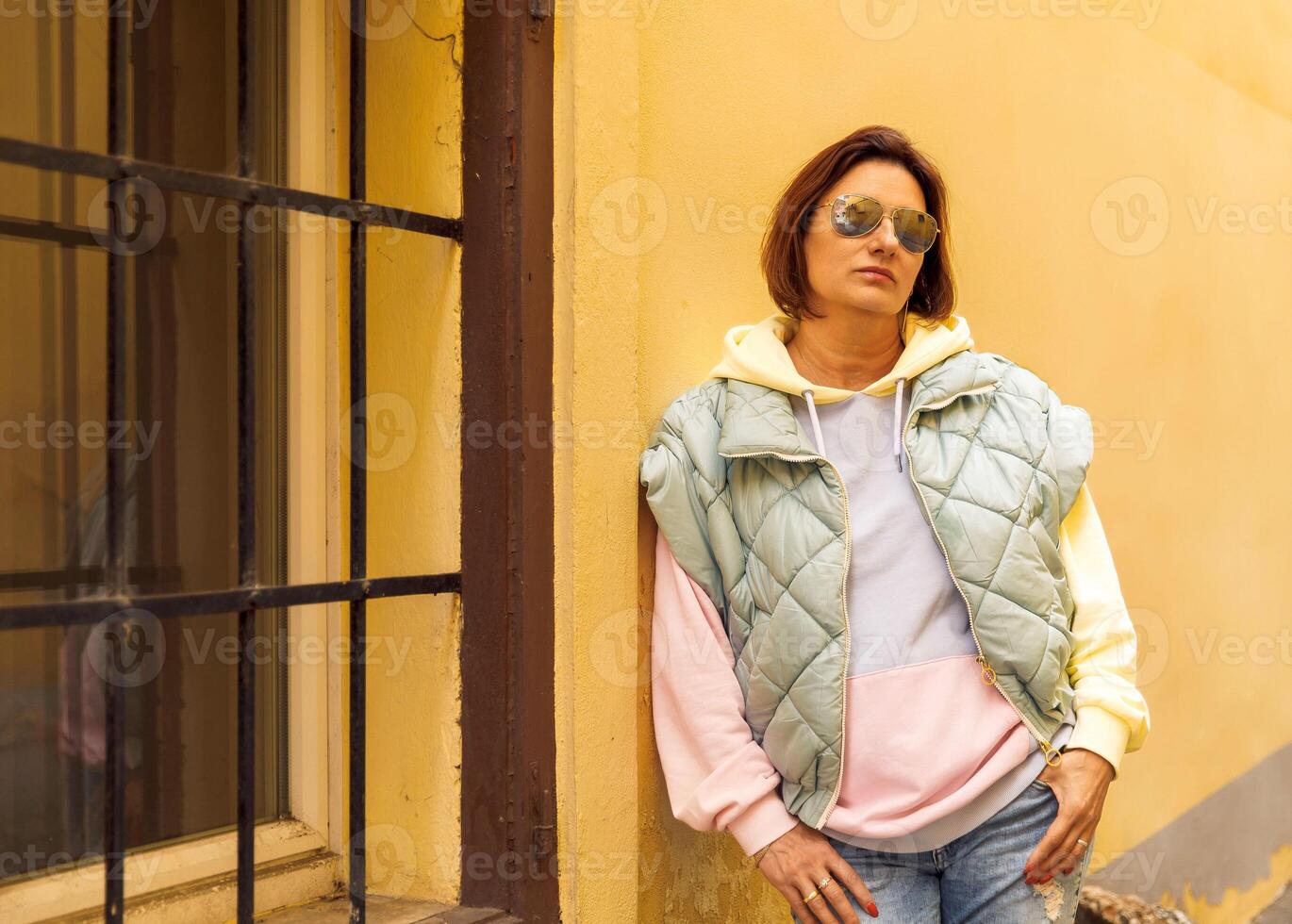 Trendy casual style with quilted jacket and sunglasses outdoors photo