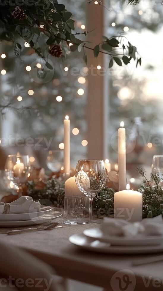 Christmas table setting decorated with burning candles, greenery and string lights photo