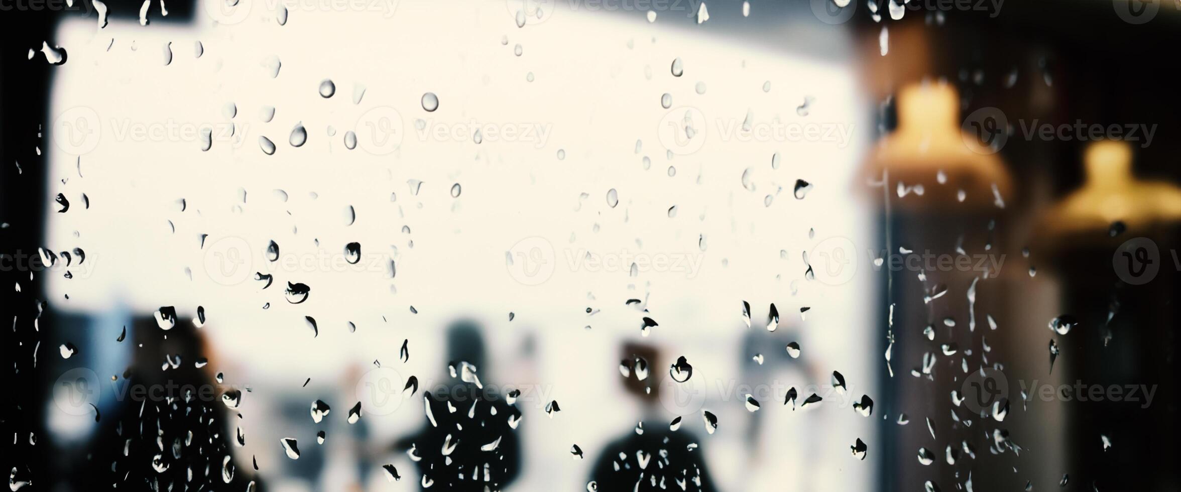 Rain drop on window glass of coffee shop and blurry city life background. Rainy season and blurry people city day life or bokeh night lights outside window. Coffee shop window covered with rain water photo