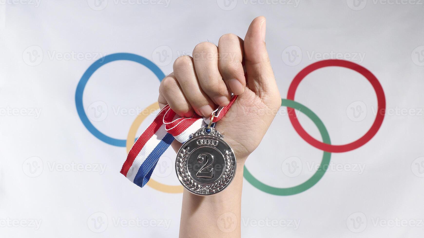 Close up of gold silver and bronze mockup trophy medals with ribbon against olympic flag mockup and white background for national or olympic sport international competition. Award and victory concept. photo
