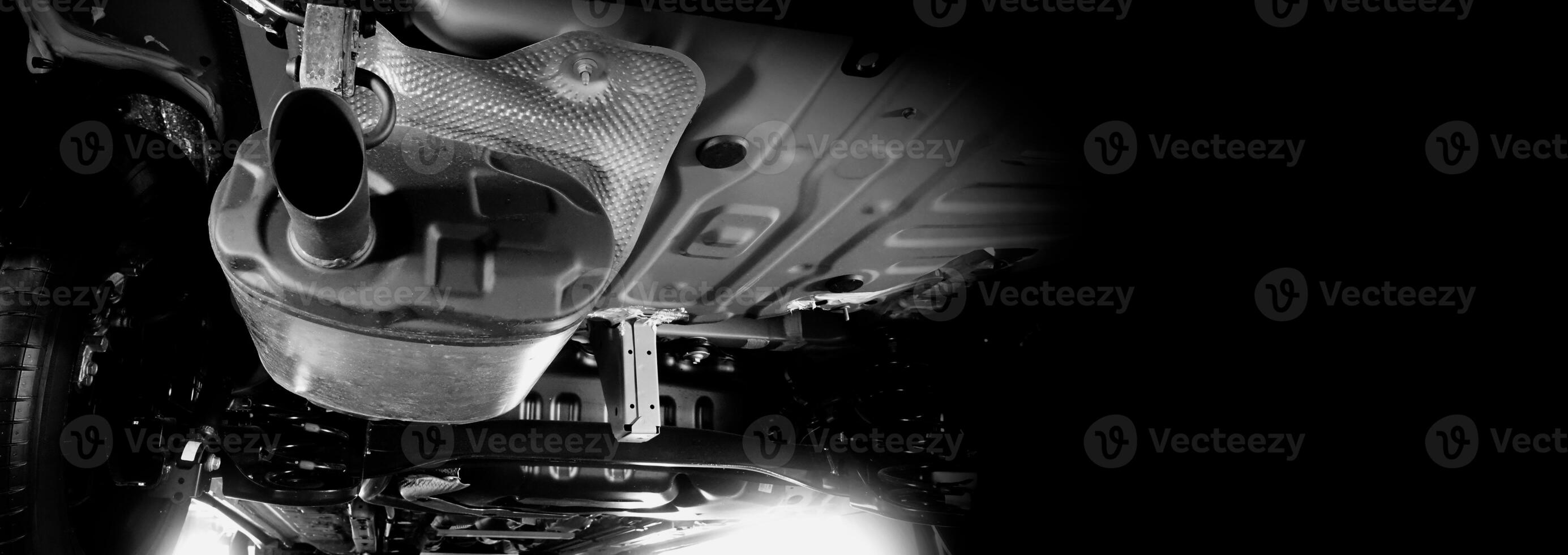 Under car exhaust pipe and suspension. Automotive mufflers. Inspection of car for Defects. Metal fittings and pipes for the muffler. Suspension elements and exhaust system. Auto parts and car service photo