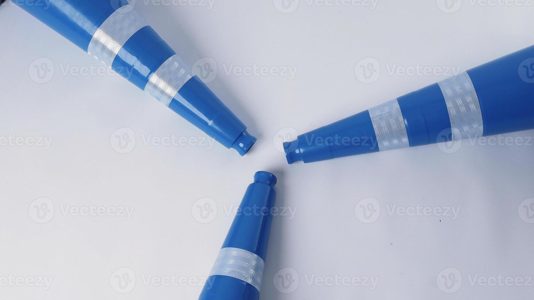 Realistic blue traffic cones and yellow safety helmet isolated on white background. photo
