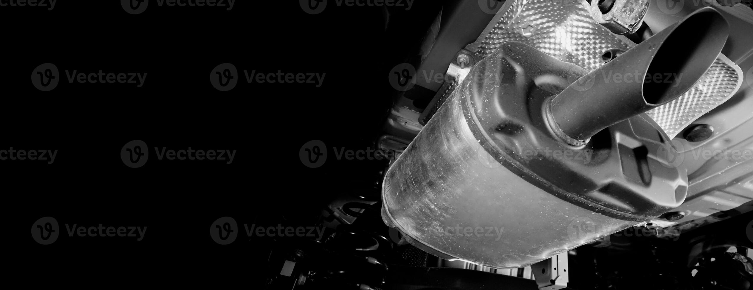 Under car exhaust pipe and suspension. Automotive mufflers. Inspection of car for Defects. Metal fittings and pipes for the muffler. Suspension elements and exhaust system. Auto parts and car service photo