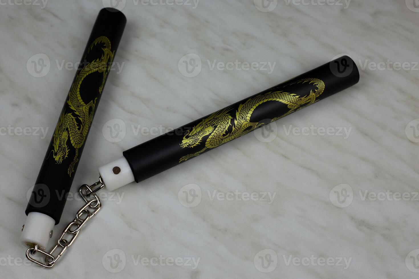 Soft foam rubber training nunchucks with steel chain, training martial arts at home using edged weapons, nunchucks for self defense training on white background photo