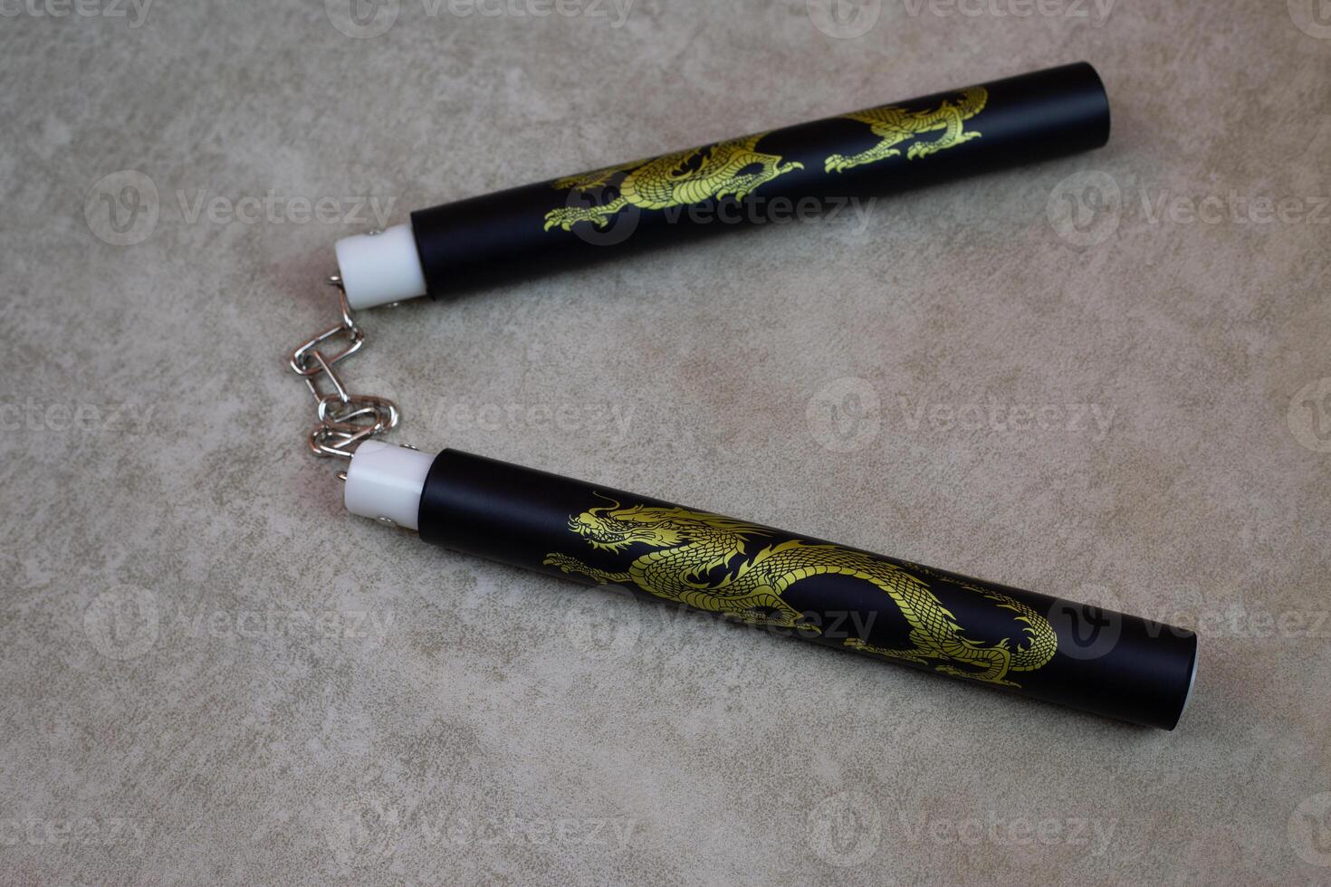 Training nunchucks made of soft material with dragon image for training martial arts at home, training weapon on light background, development of agility skills at home, martial arts culture photo