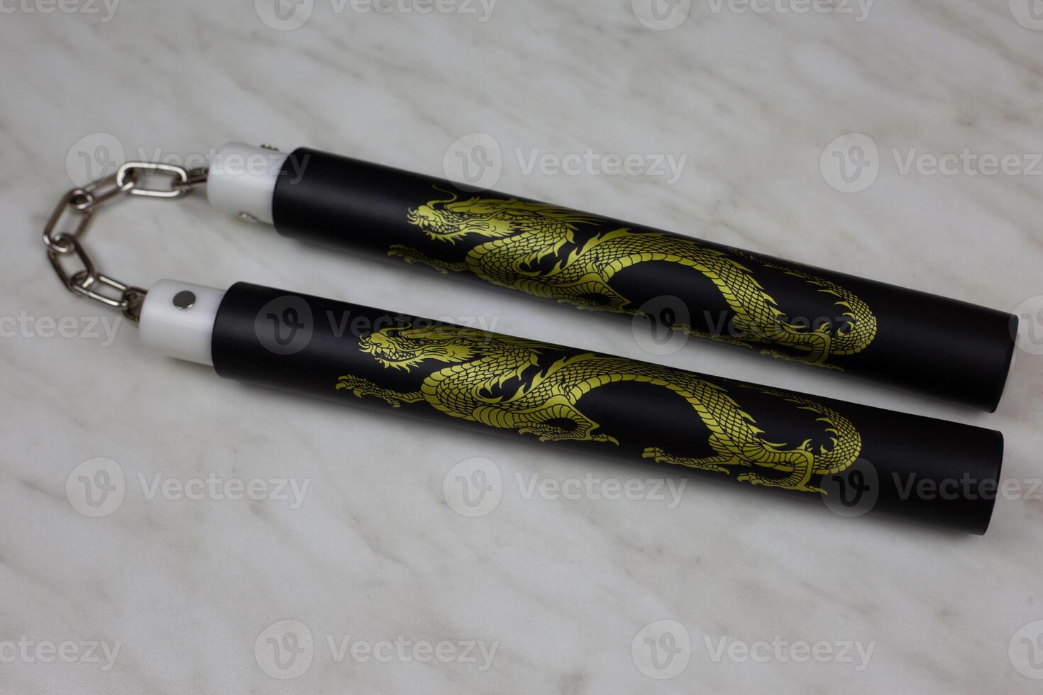 Training nunchucks made of soft material on white background, oriental inertial edged weapons of impact, shock-crushing and suffocating action, foam rubber training nunchucks photo