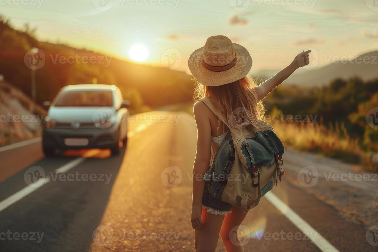 girl tourist catches a car on the road , hitchhiking photo