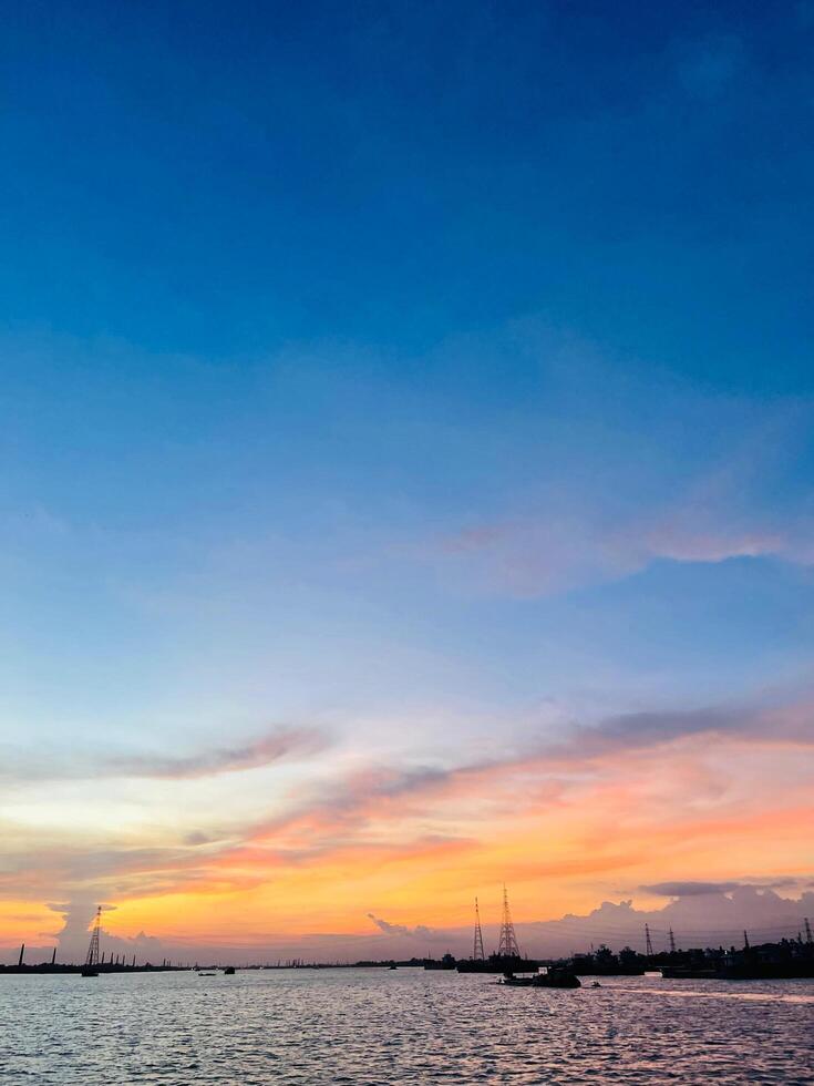 Aerial view to sunset on the river at summer evening with cloudy sky. photo