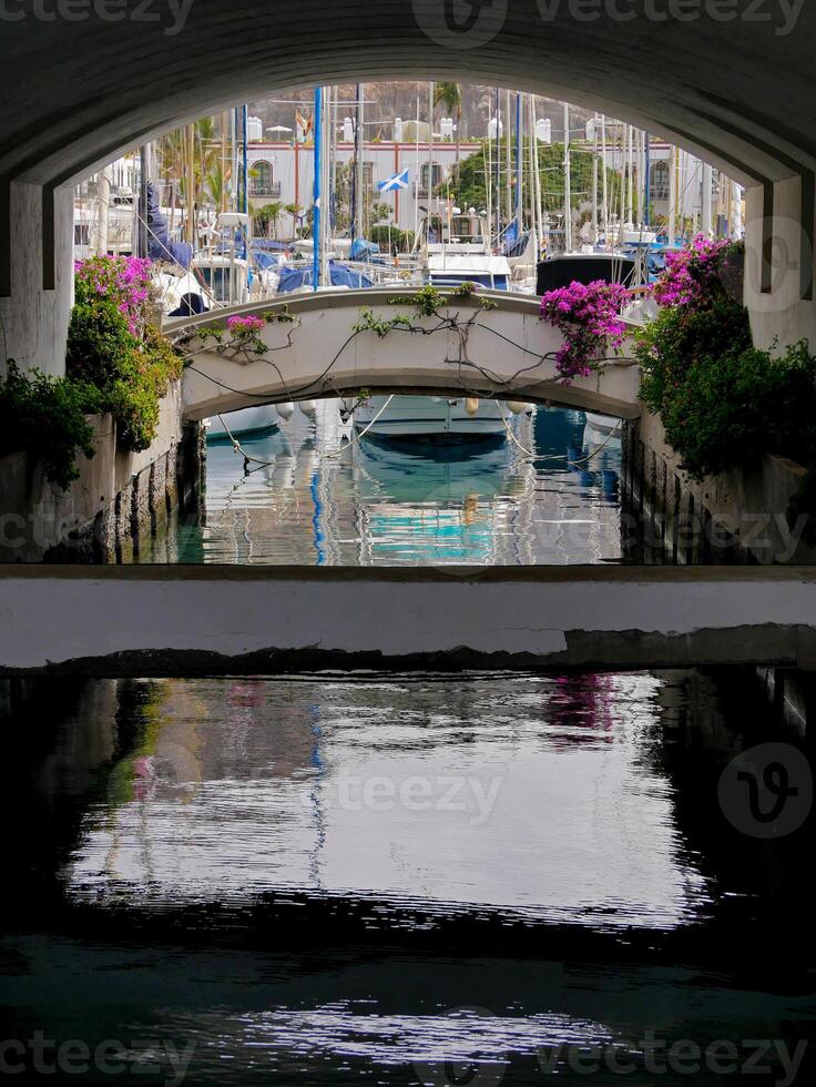 A view of the harbor pier through the arch in Puerto de Mogan, Gran Canaria photo