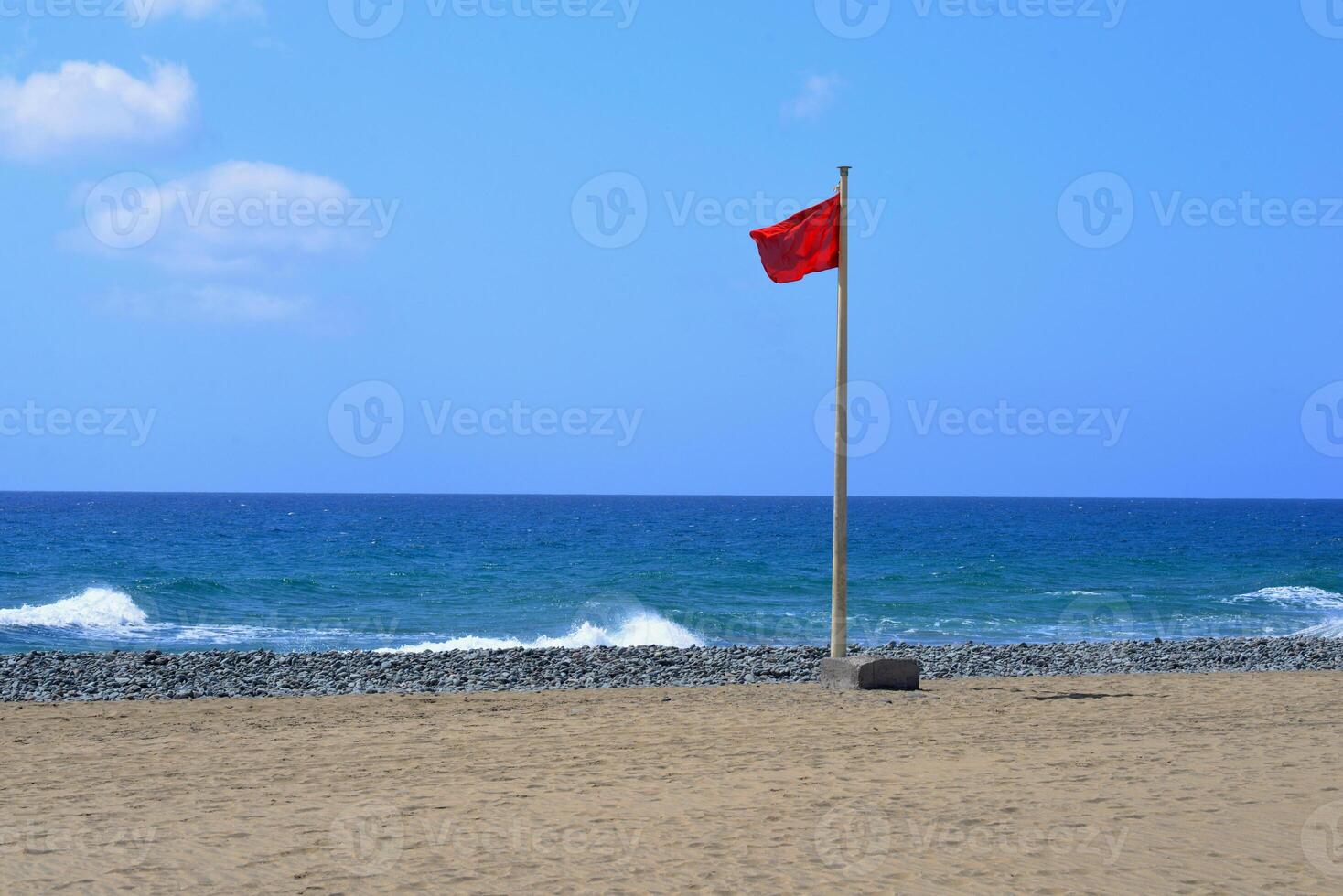Red flag on the beach of Gran Canaria. Swimming is prohibited photo