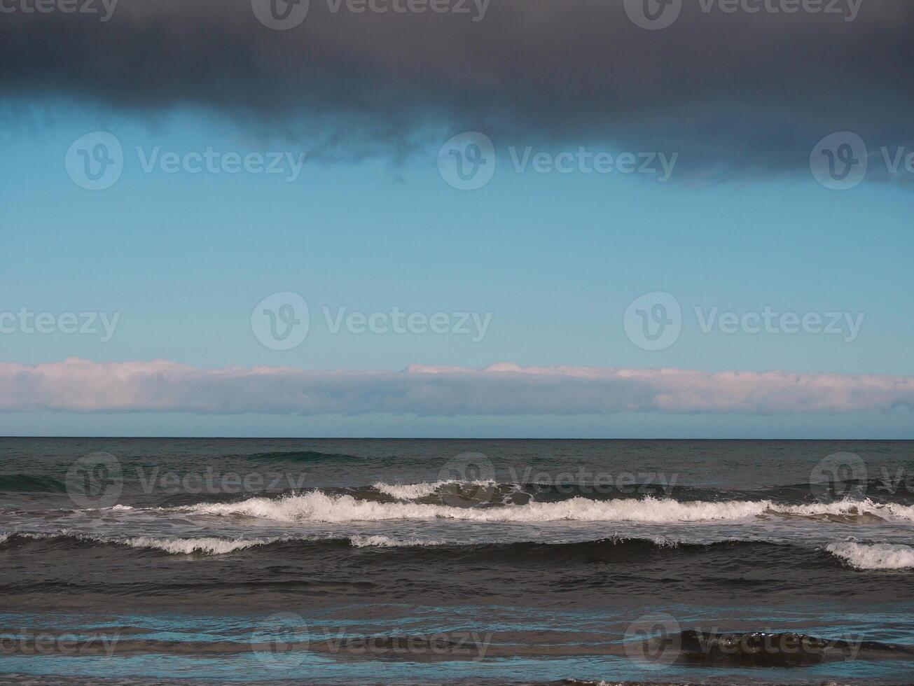 Sea with waves at dusk under a cloudy sky, Gran Canaria. Seascape background wallpaper with copy space photo