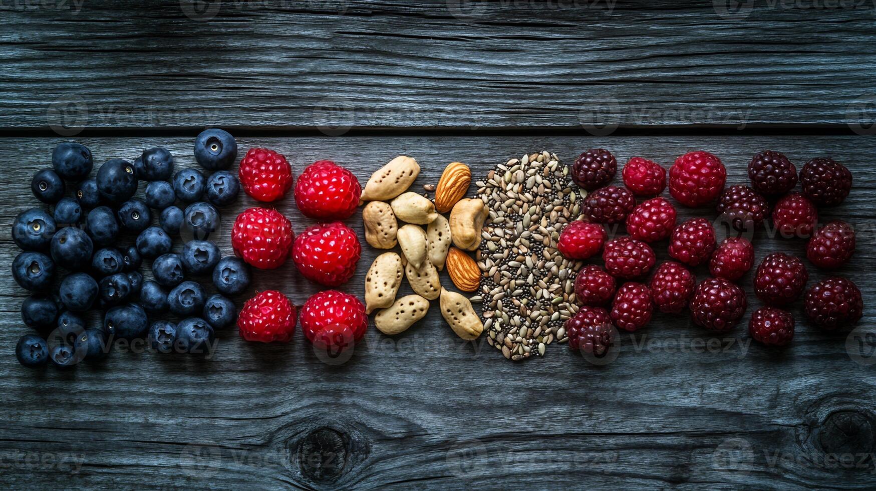 A variety of berries and nuts are arranged in a row photo