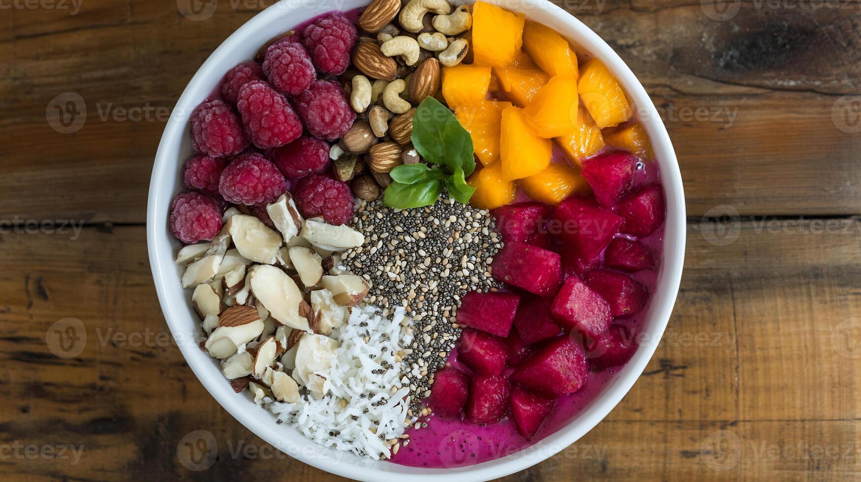 A bowl of fruit and nuts with a spoon photo