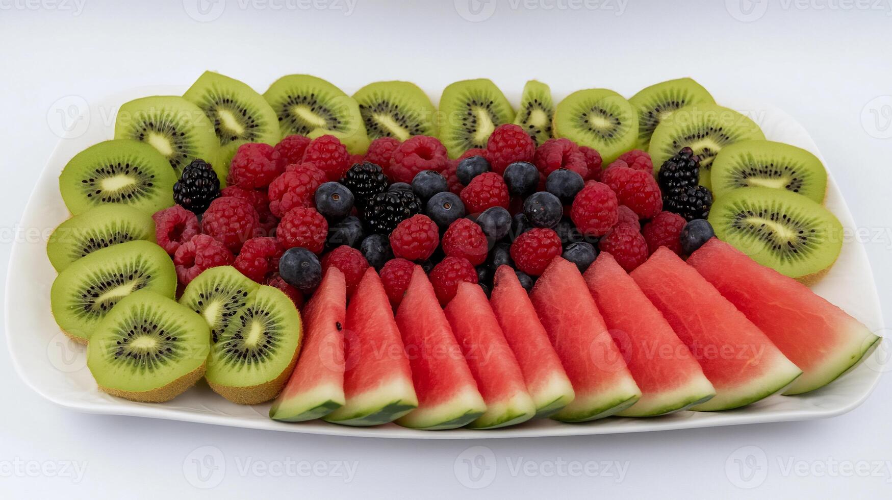 A plate of sliced fruit on a white background photo