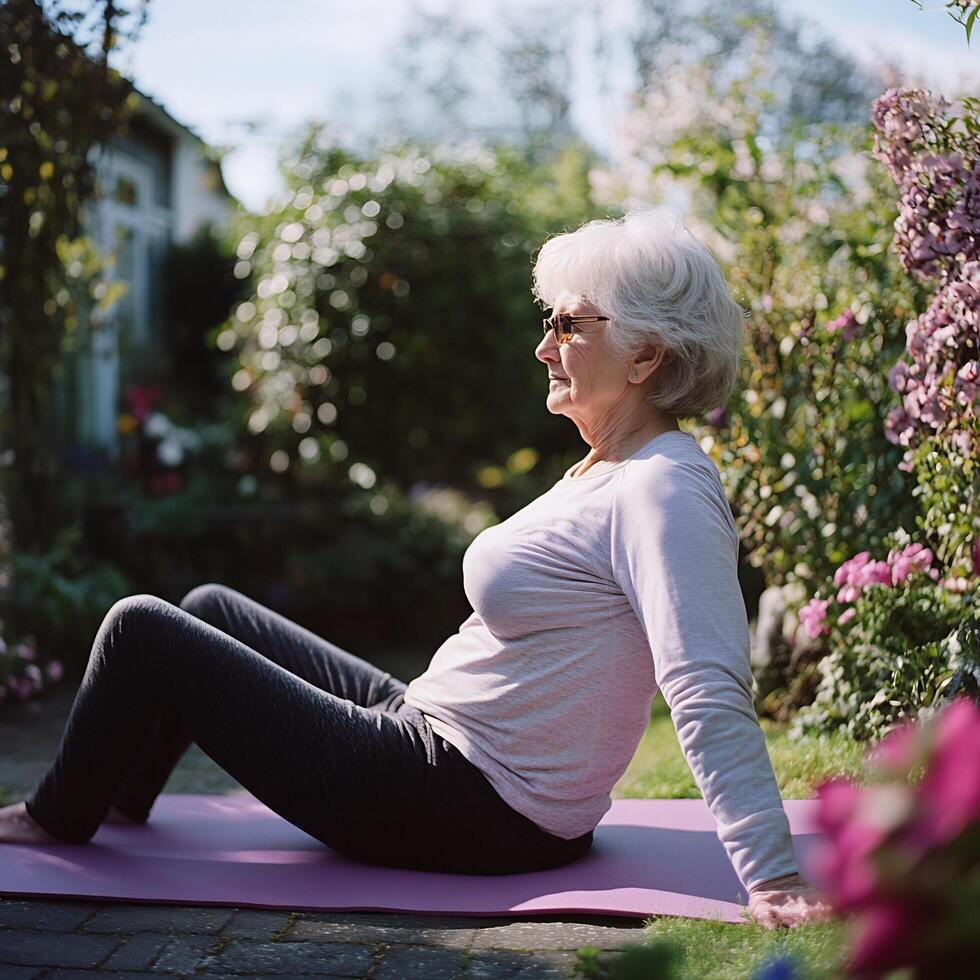 An older woman is sitting on a yoga mat photo