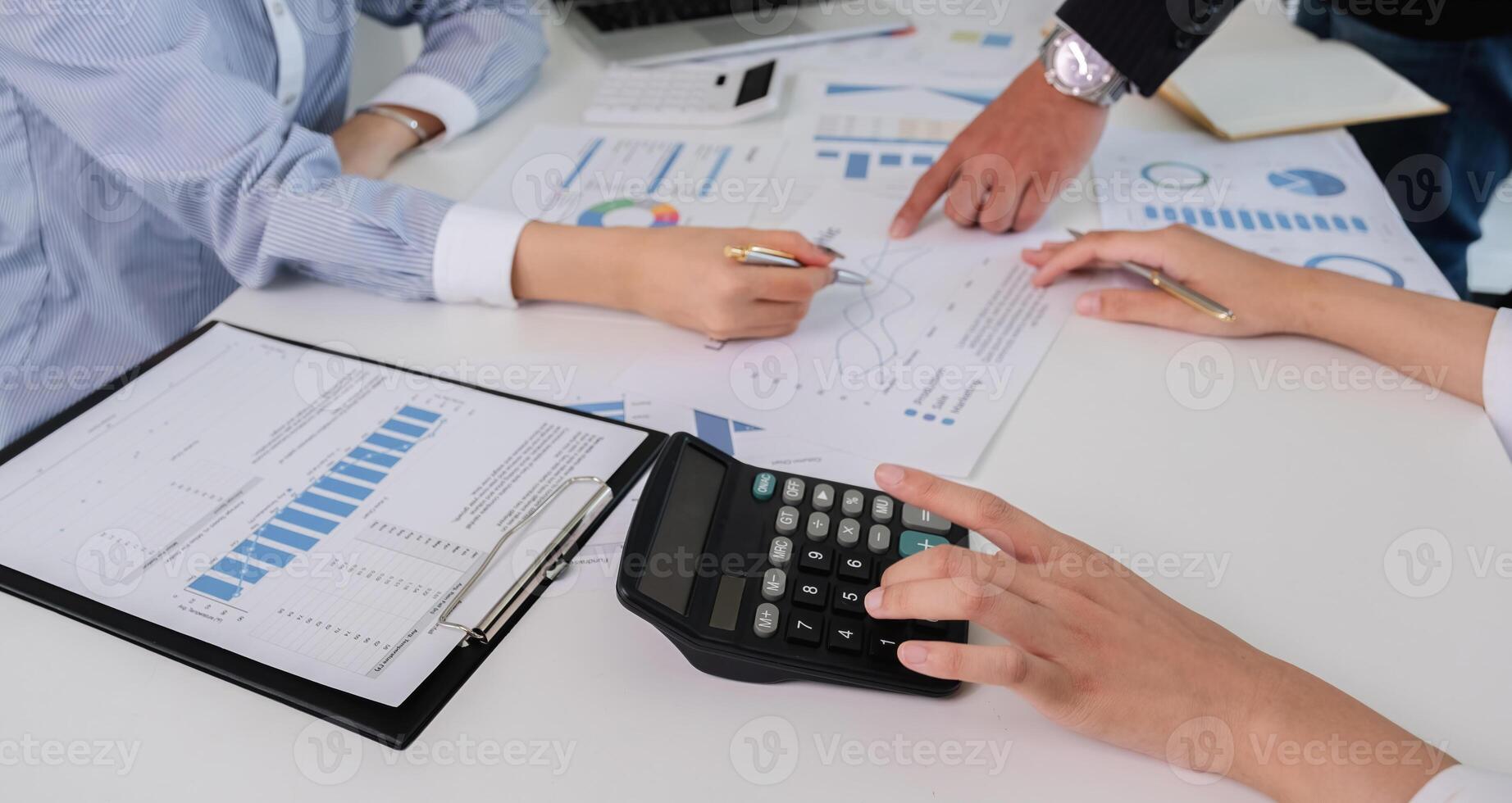Team of Accountant Collaborating on Financial Calculation and Data Analysis in a Modern Office Setting photo
