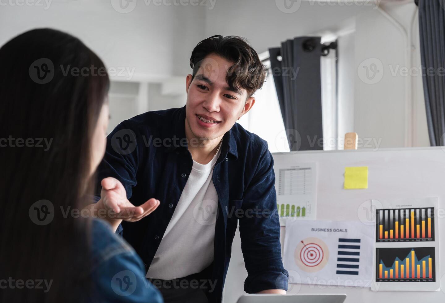 Diverse Team of Business Professionals Engaging in Discussion and Sharing Ideas in a Modern Office Setting photo