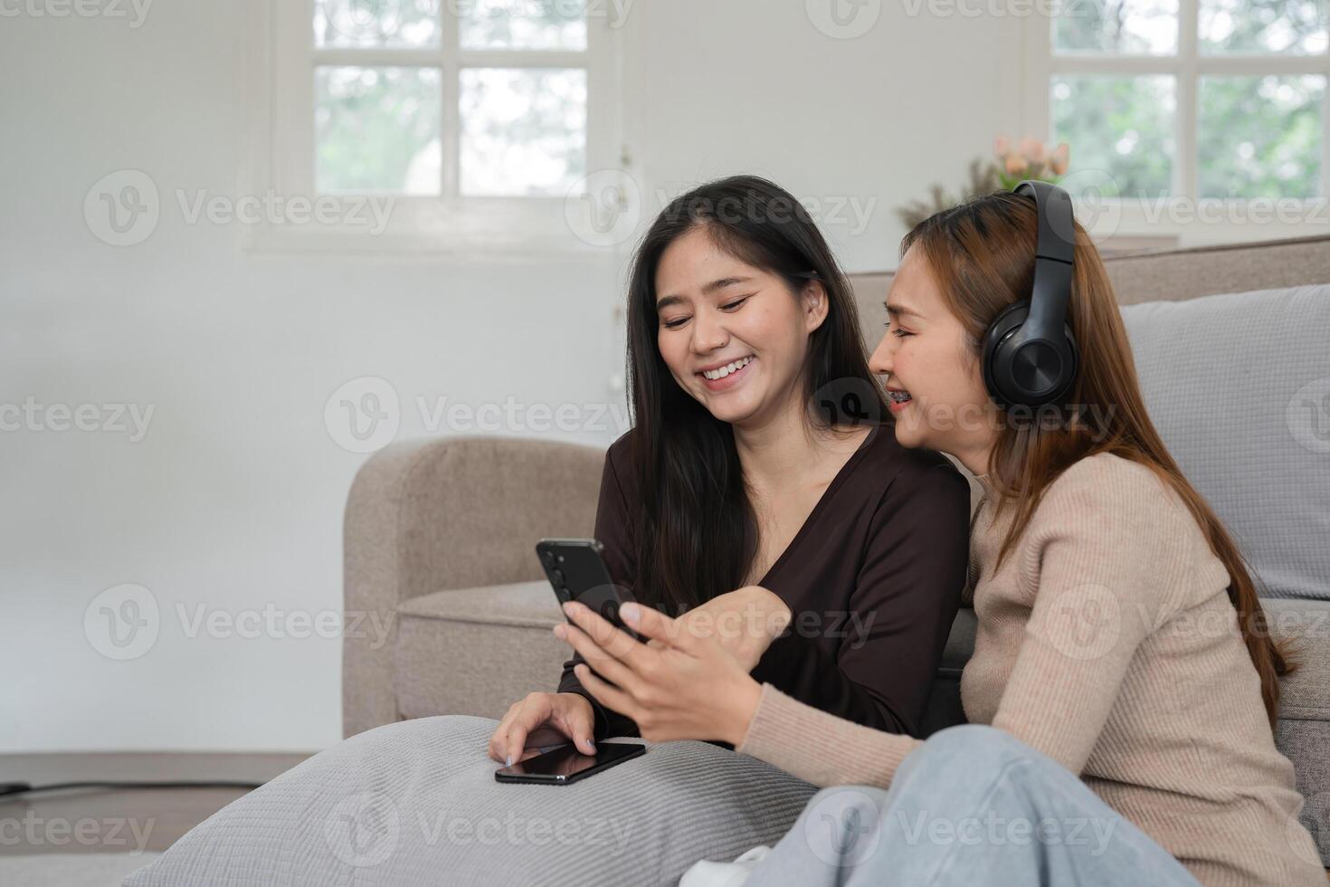 Cozy Lesbian Couple Relaxing in Modern Living Room, Enjoying Quality Time Together with Technology and Comfort photo
