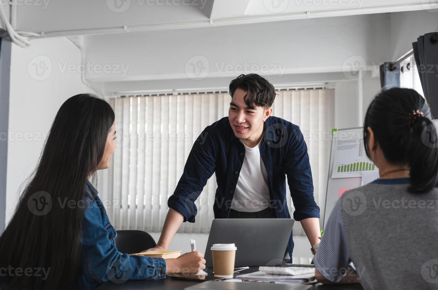 Team of Business People Engaging in a Discussion and Exchanging Ideas in a Modern Office Setting photo