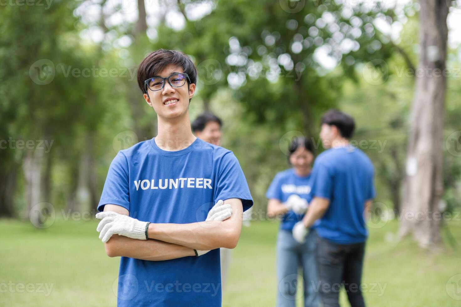 Group of Volunteers Collecting Trash in a Park to Promote Environmental Conservation and Community Service photo