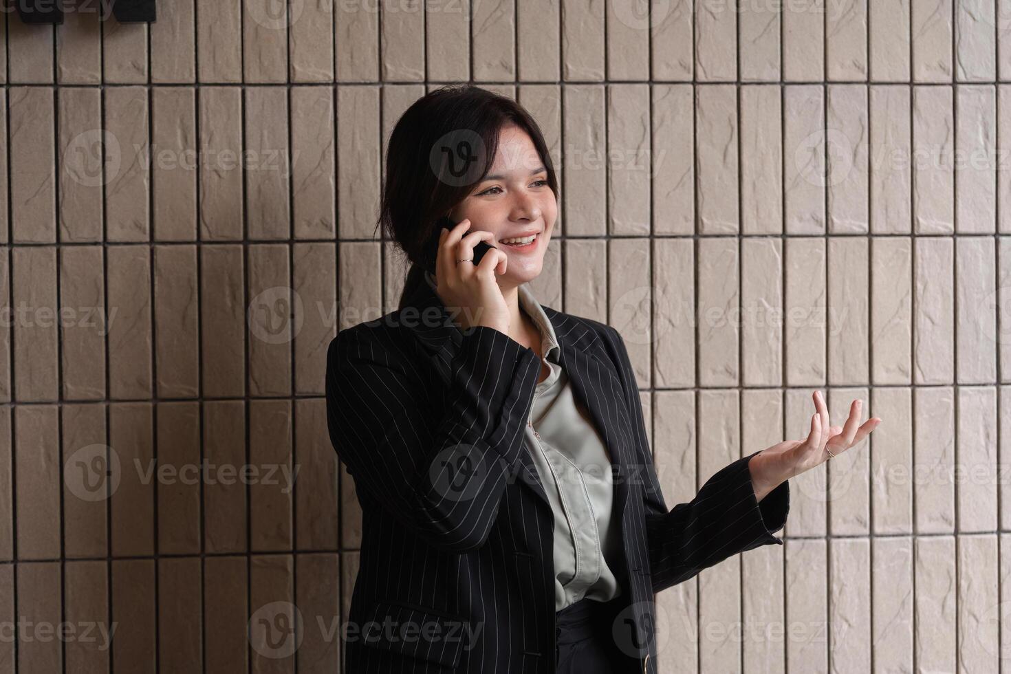 Confident Businesswoman Communicating with Clients via Telephone in Modern Office Setting for Professional Customer Engagement photo