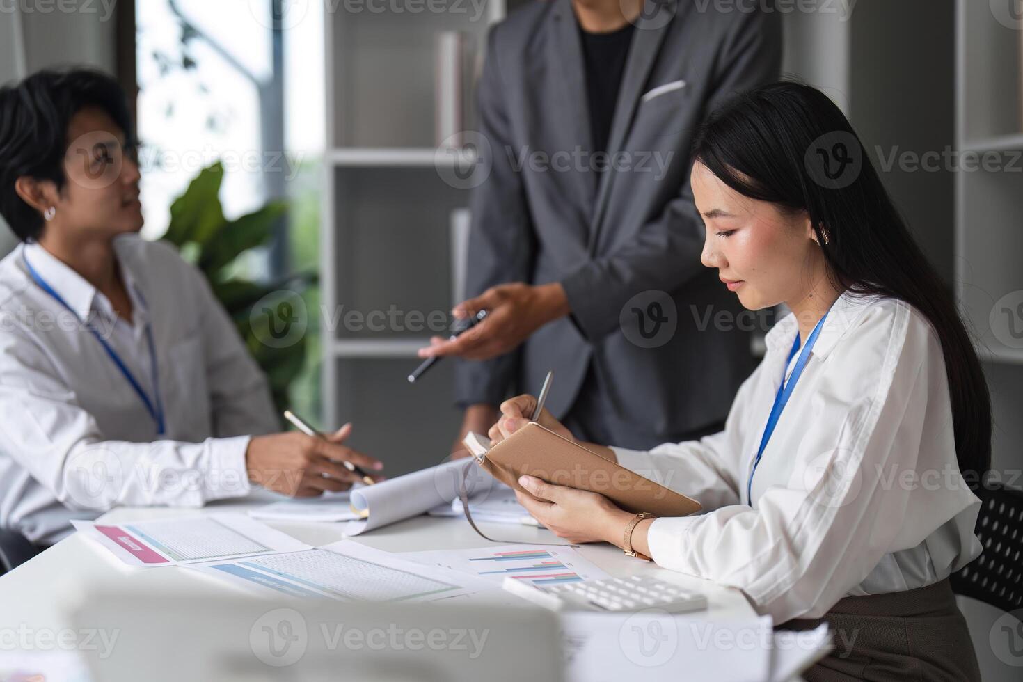 Business People in a Modern Office Meeting, Discussing Strategies and Taking Notes for Future Projects photo