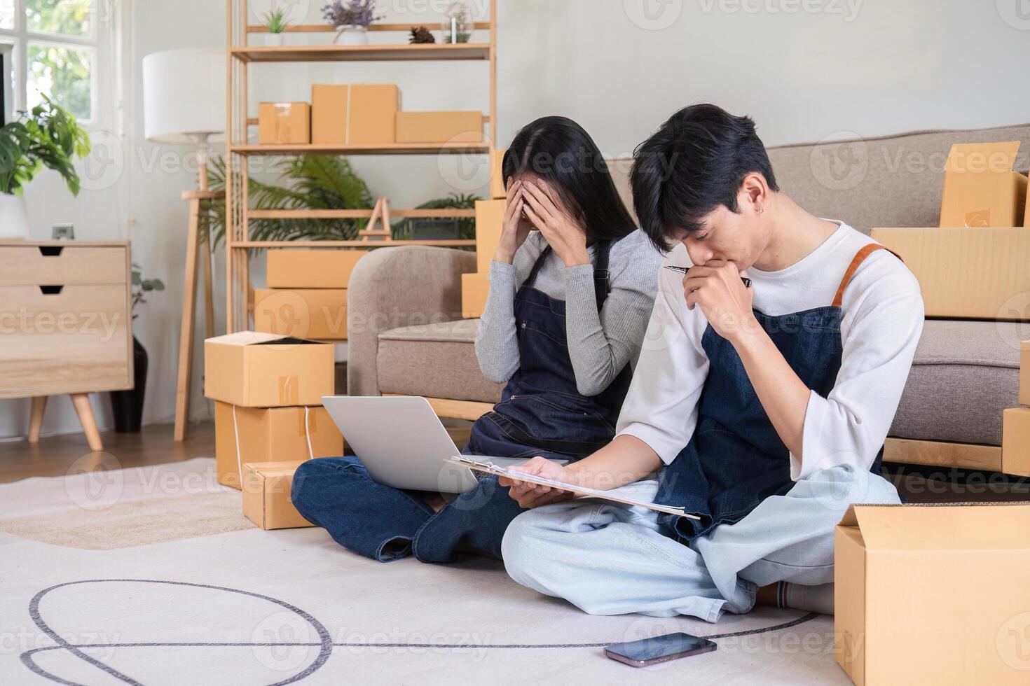 Stressed Couple Managing Online Business Facing Issues with Wrong Order Amidst Packaging Boxes at Home photo