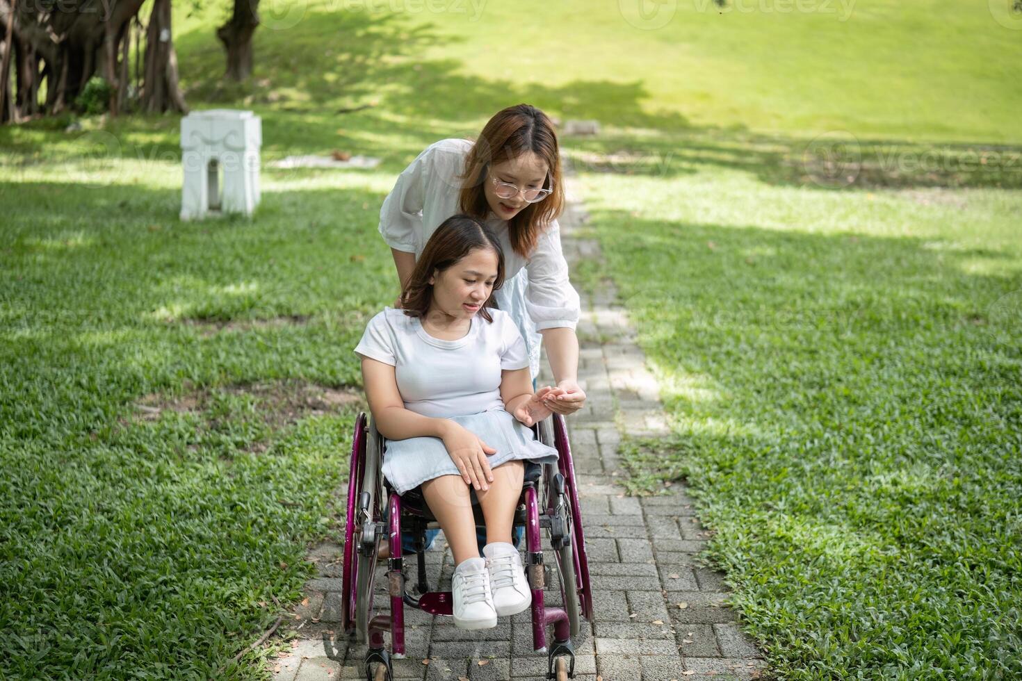 Young Disabled Woman and Best Friend Enjoying Outdoor Activities Together in a Park Setting photo
