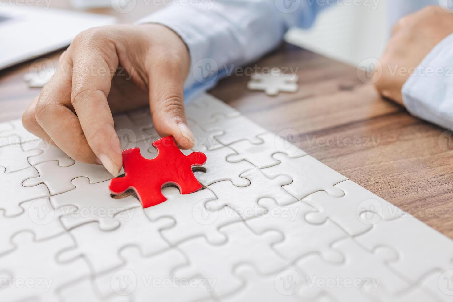 Hand push last piece jigsawto finish success planning concept solve puzzle, logical thinking, Concept of challenge and determination as the person works to complete the puzzle. photo