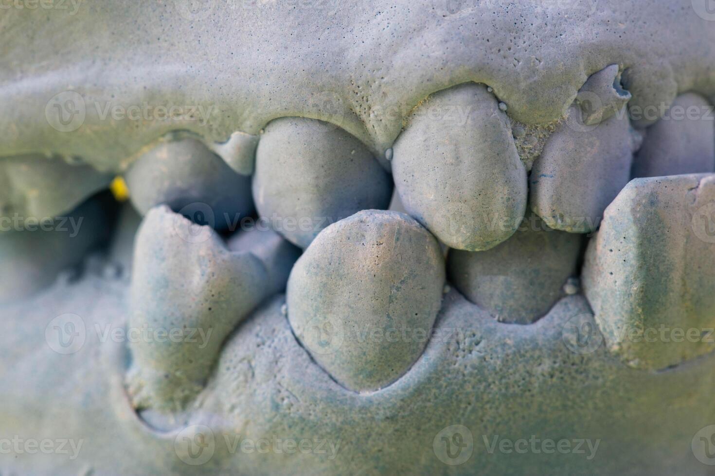 Blue plaster impression of the dental jaw of a patient with crooked teeth and malocclusions. Manufacturing of dentures and crowns based on orthodontic impressions, close-up photo