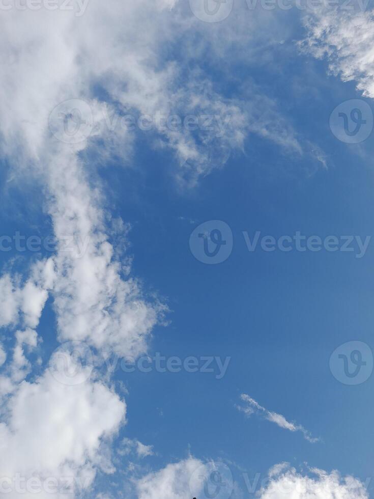 Beautiful white clouds on deep blue sky background. Large bright soft fluffy clouds are cover the entire blue sky. photo