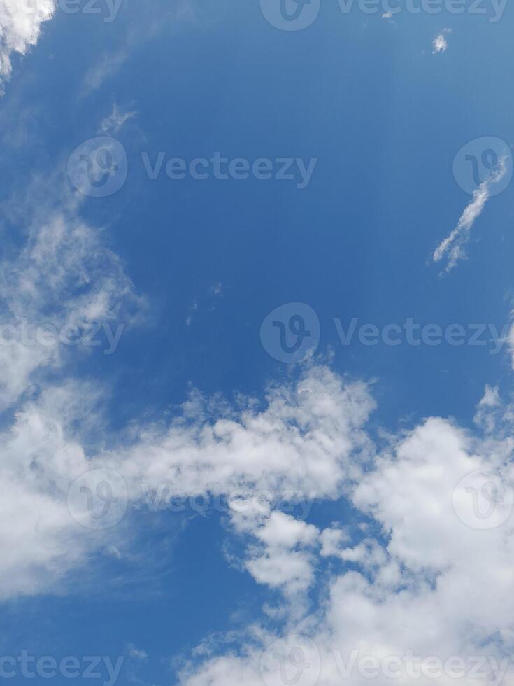 Beautiful white clouds on deep blue sky background. Large bright soft fluffy clouds are cover the entire blue sky. photo