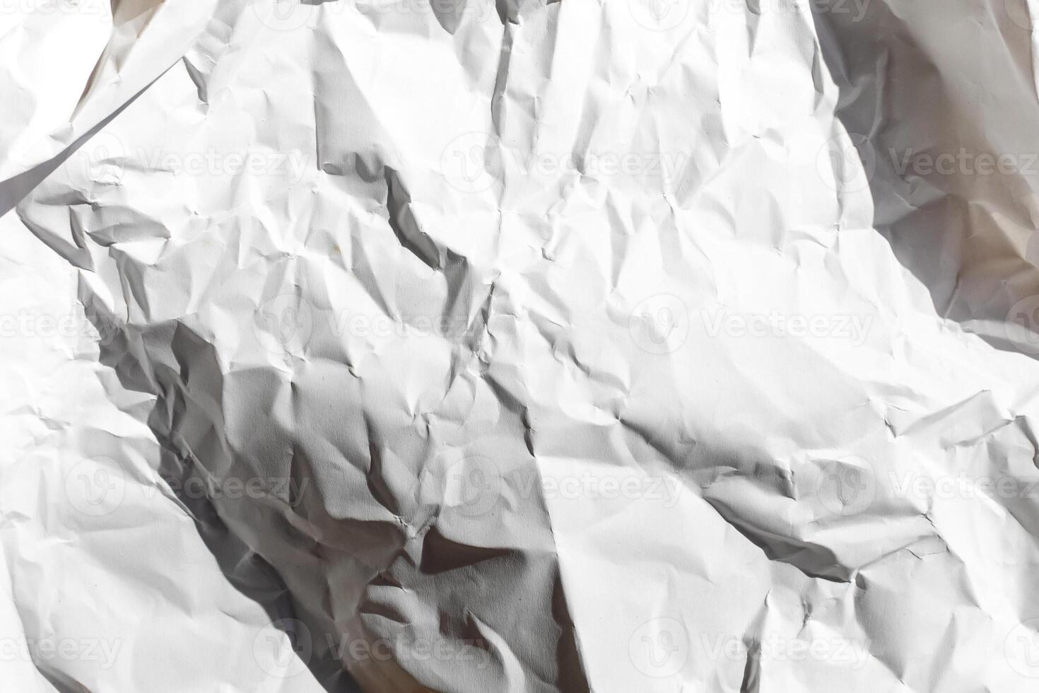 Crumpled white paper texture symbolizing creativity challenges and brainstorming, ideal for concepts related to problem solving and innovation photo
