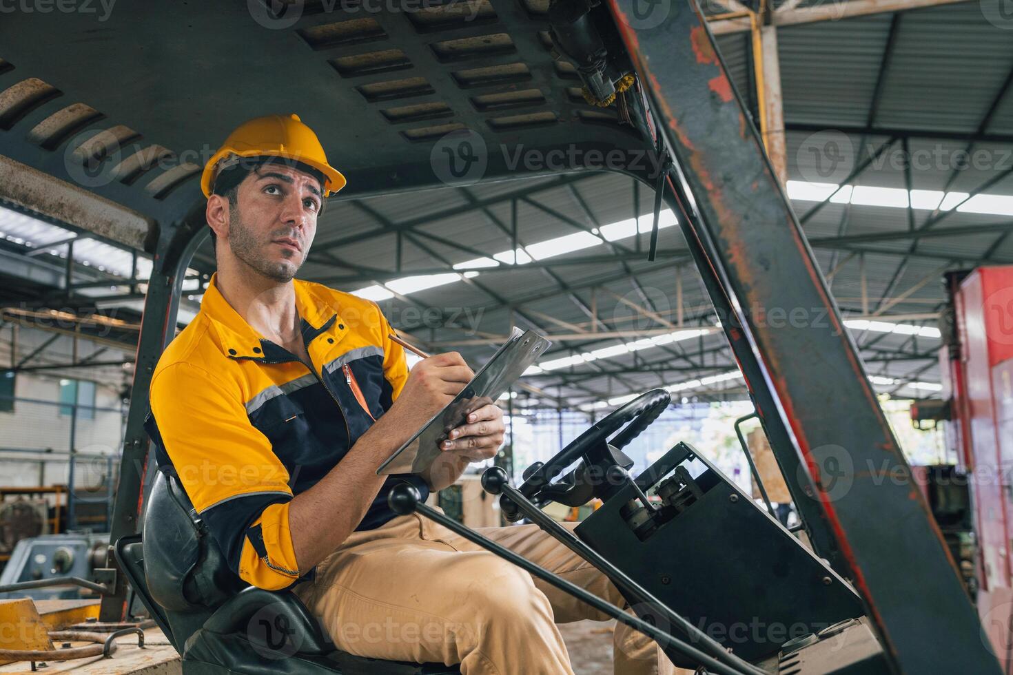 Caucasian engineer using a laptop in a factory. man working in plastics factory. photo