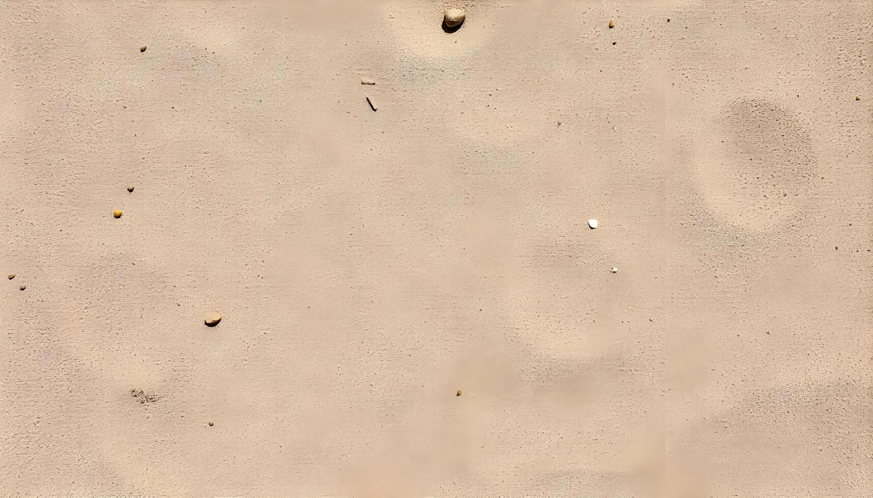 Textured Sand with Scattered Pebbles photo