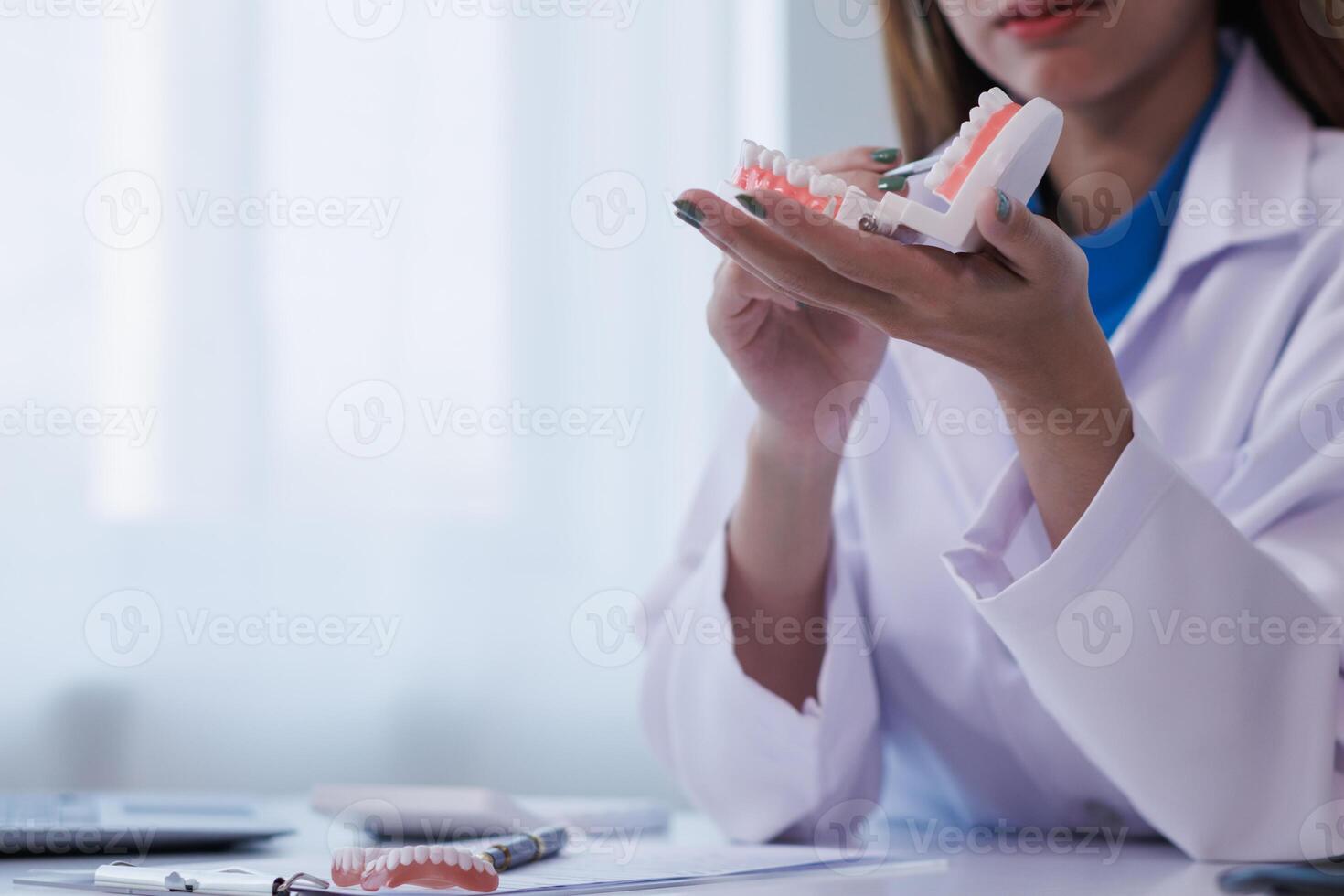 woman consults dentist about her toothache for treatment in dental clinic and dentist gives advice on right symptoms and treatment method for patient. concept consulting dentist about dental treatment photo