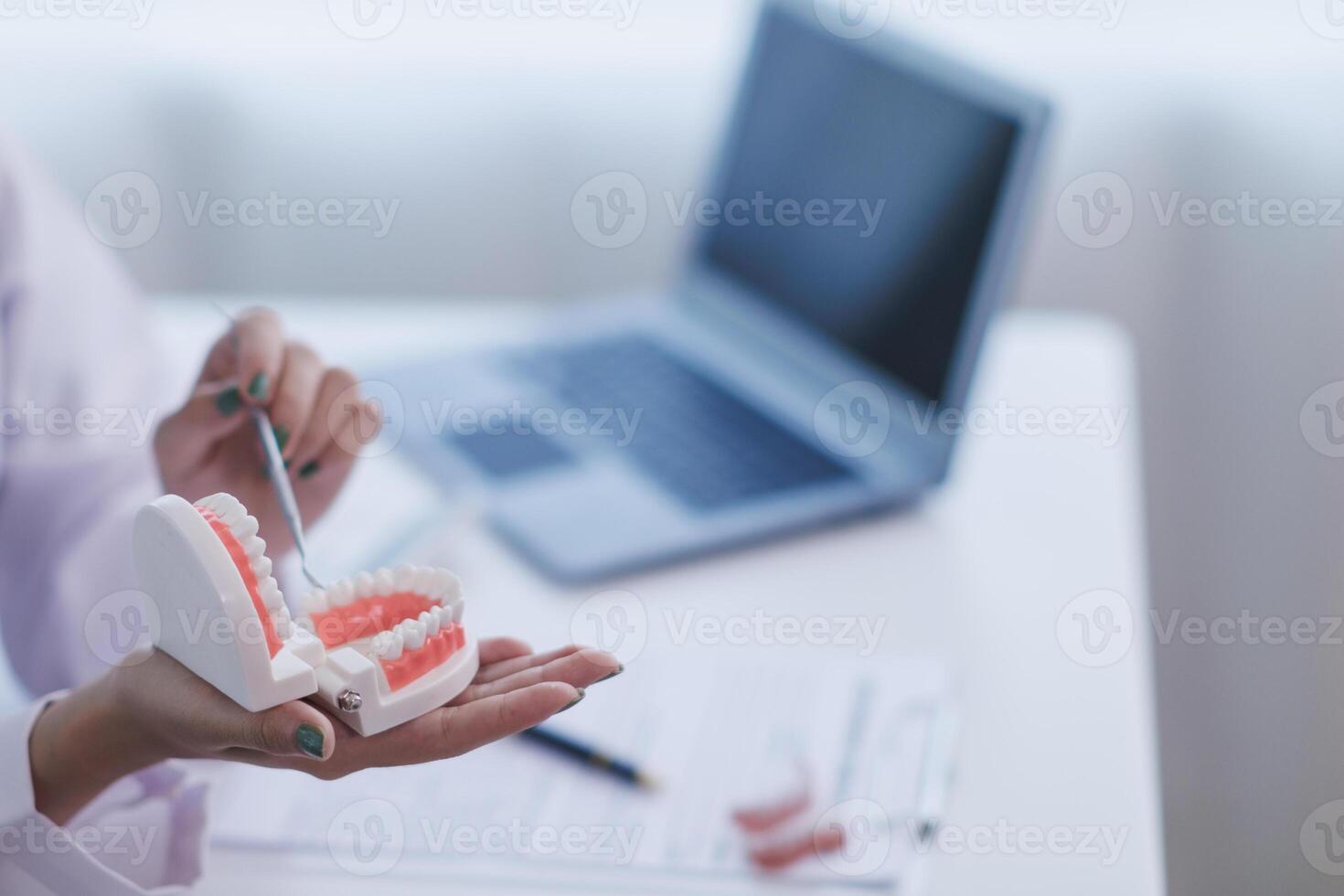 woman consults dentist about her toothache for treatment in dental clinic and dentist gives advice on right symptoms and treatment method for patient. concept consulting dentist about dental treatment photo