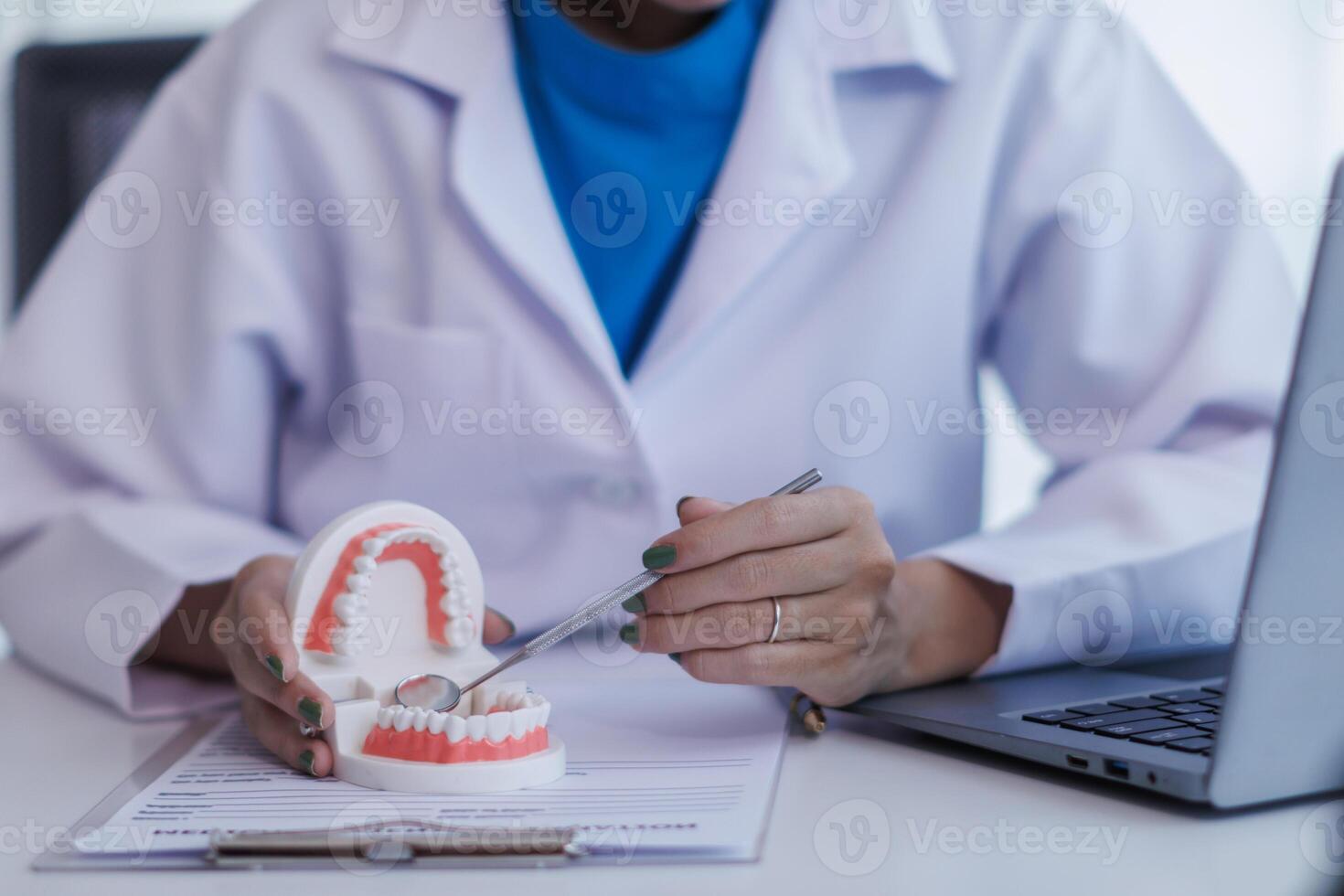 woman consults dentist about her toothache for treatment in dental clinic and dentist gives advice on right symptoms and treatment method for patient. concept consulting dentist about dental treatment photo