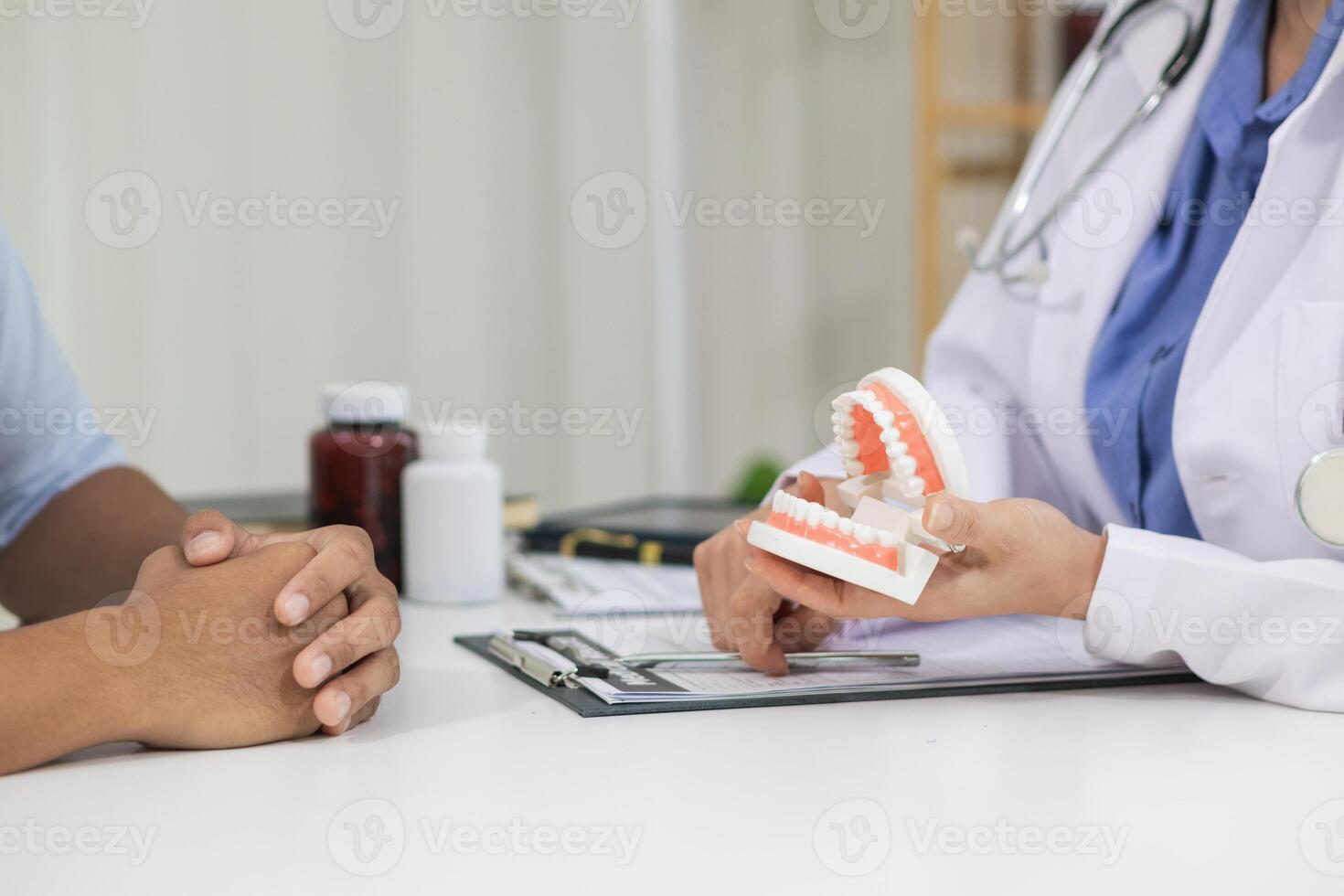 woman consults dentist about her toothache for treatment in dental clinic and dentist gives advice on right symptoms and treatment method for patient. concept consulting dentist about dental treatment photo
