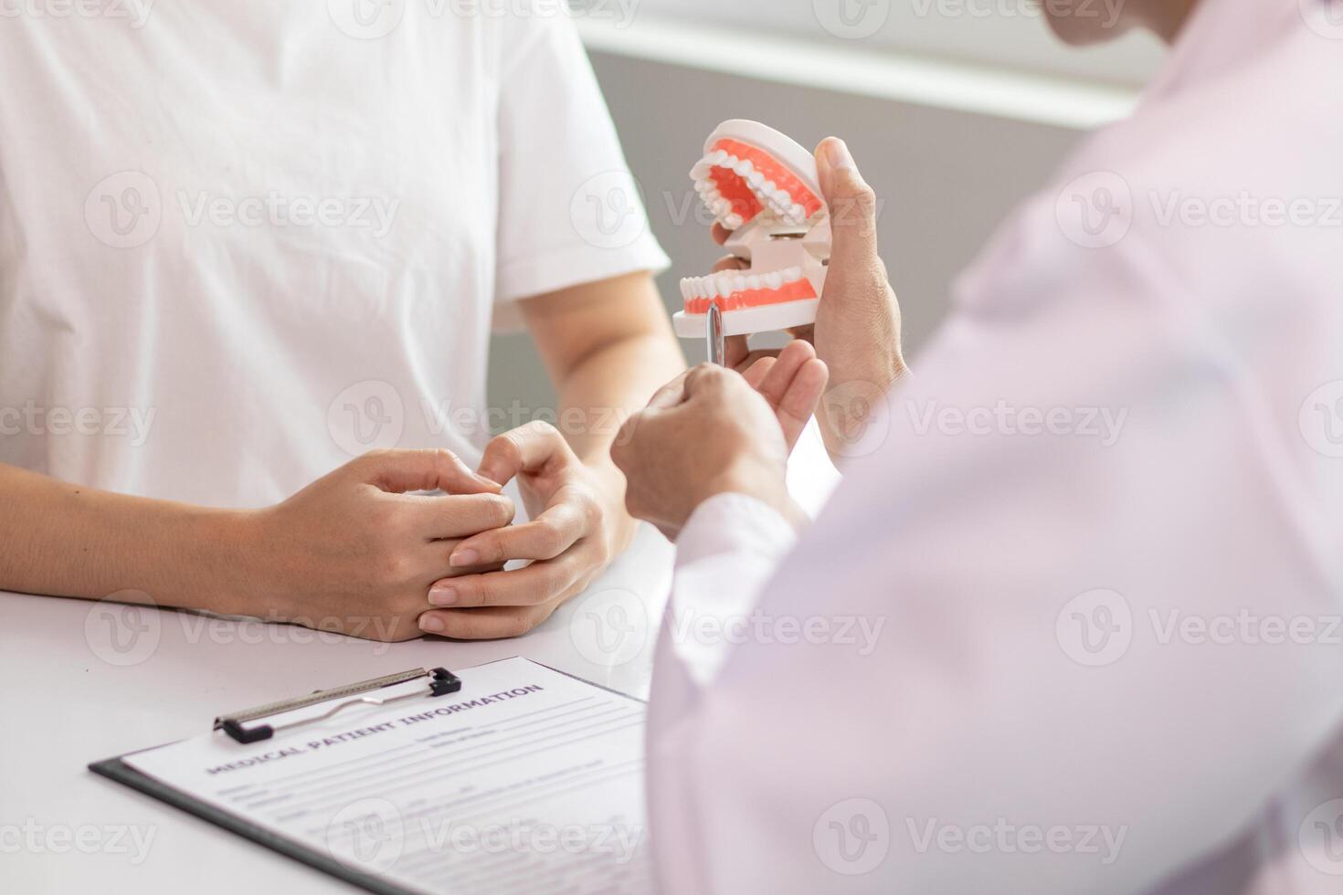 woman consults dentist about her toothache for treatment in dental clinic and dentist gives advice on right symptoms and treatment method for patient. concept consulting dentist about dental treatment photo