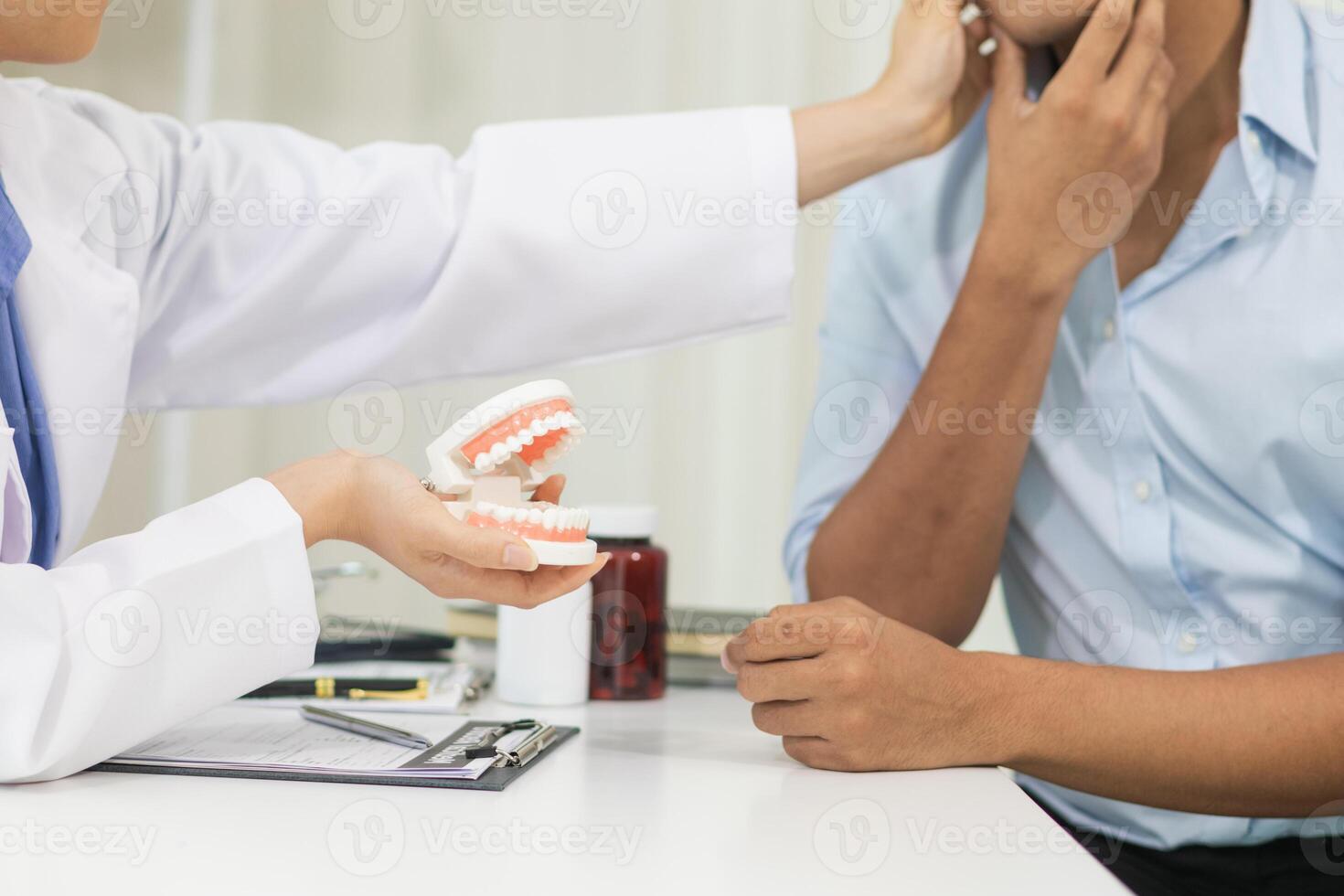 woman consults dentist about her toothache for treatment in dental clinic and dentist gives advice on right symptoms and treatment method for patient. concept consulting dentist about dental treatment photo