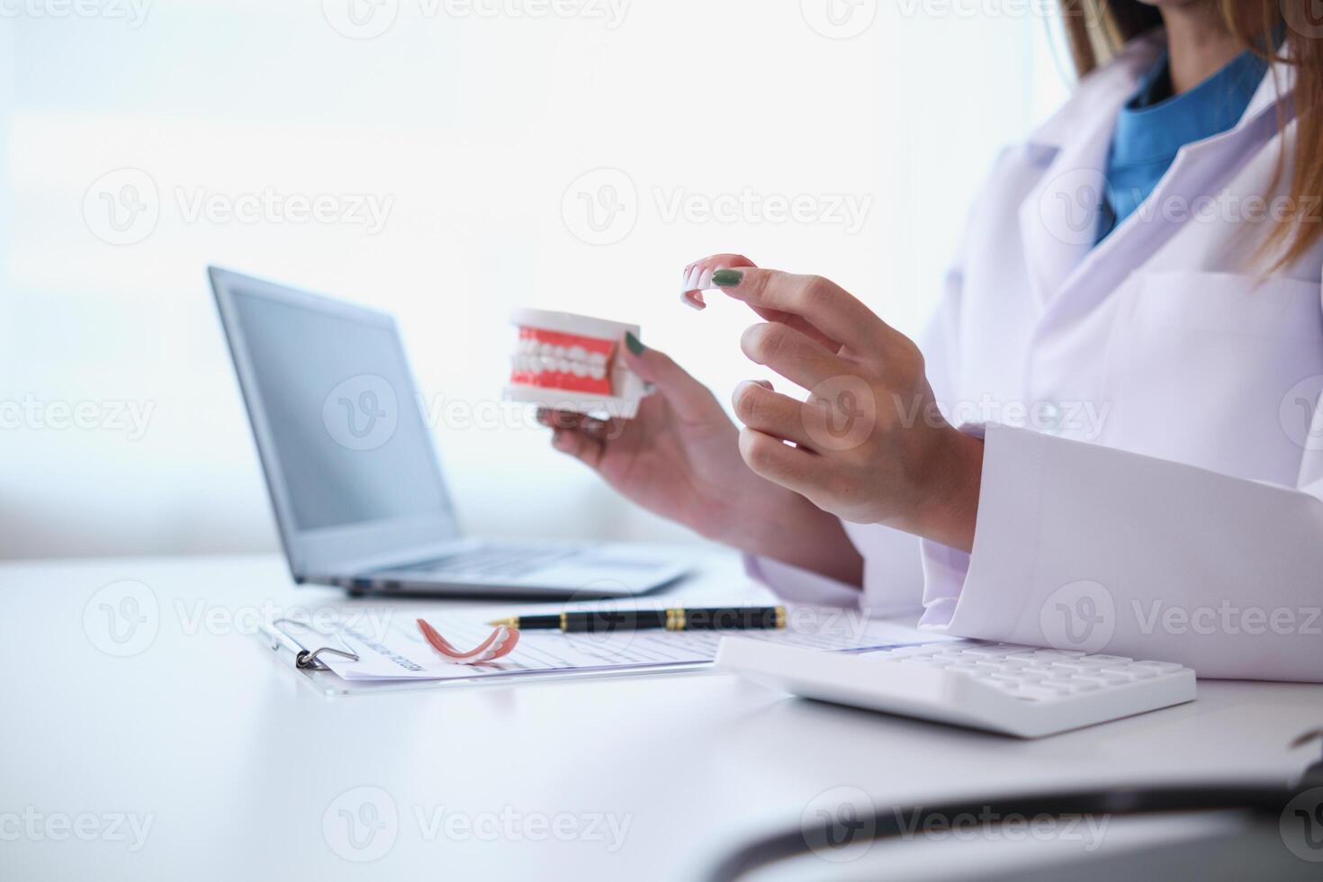 woman consults dentist about her toothache for treatment in dental clinic and dentist gives advice on right symptoms and treatment method for patient. concept consulting dentist about dental treatment photo